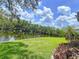 Picturesque waterfront view with lush green trees reflected in the calm water at 9631 Oak Ne St, St Petersburg, FL 33702