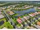 Aerial view of the home showcasing beautiful lake views and lush landscaping in a desirable neighborhood at 16227 Cape Coral Dr, Wimauma, FL 33598