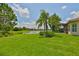 Lush backyard featuring a view of the lake and a screened lanai at 16227 Cape Coral Dr, Wimauma, FL 33598