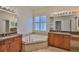 Dual sink bathroom with large soaking tub and granite counters at 16227 Cape Coral Dr, Wimauma, FL 33598