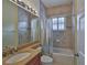 Tiled bathroom features a large vanity with granite countertop and a shower-tub combo at 16227 Cape Coral Dr, Wimauma, FL 33598