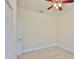Cozy bedroom featuring neutral carpet, ceiling fan, and fresh paint at 16227 Cape Coral Dr, Wimauma, FL 33598