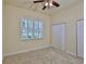 Carpeted bedroom with window, closet, and door at 16227 Cape Coral Dr, Wimauma, FL 33598