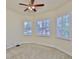 Bright bedroom features neutral carpet, white trim, and large shuttered windows at 16227 Cape Coral Dr, Wimauma, FL 33598