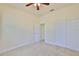 Bedroom with neutral carpet, white trim, a ceiling fan and a sliding door closet at 16227 Cape Coral Dr, Wimauma, FL 33598