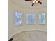 Bedroom with neutral carpet, white trim, a ceiling fan and views of the outdoors at 16227 Cape Coral Dr, Wimauma, FL 33598