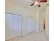 Carpeted bedroom with ceiling fan, closets, and access to bath at 16227 Cape Coral Dr, Wimauma, FL 33598
