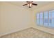 Bedroom boasts neutral carpet, white trim, shuttered doors, and ceiling fan at 16227 Cape Coral Dr, Wimauma, FL 33598