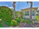 Close up on the home's well manicured flower bed and tropical landscaping at 16227 Cape Coral Dr, Wimauma, FL 33598