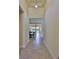 Hallway view of the home leading to the open living areas and outdoor pool at 16227 Cape Coral Dr, Wimauma, FL 33598
