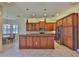 Open kitchen features granite counters, pendant lighting, and stainless steel appliances at 16227 Cape Coral Dr, Wimauma, FL 33598