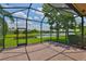 Relaxing screened lanai showcases tranquil water views and brick floor at 16227 Cape Coral Dr, Wimauma, FL 33598