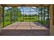 Screened lanai with brick flooring overlooking a scenic lake at 16227 Cape Coral Dr, Wimauma, FL 33598