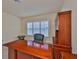 Bright office with a large window, desk, and wood built-in, creating an inviting and functional workspace at 16227 Cape Coral Dr, Wimauma, FL 33598
