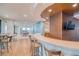 Beautiful bar area with wood accents, television, seating, and an open floor plan with tables at 1 Beach Se Dr # 1902, St Petersburg, FL 33701