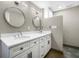 Bathroom featuring a double vanity with quartz countertops, decorative mirrors, and updated fixtures at 1 Beach Se Dr # 1902, St Petersburg, FL 33701
