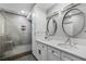Bright bathroom boasts double sinks, white cabinets and hardware with a large glass shower at 1 Beach Se Dr # 1902, St Petersburg, FL 33701