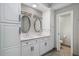 Bright bathroom boasts double sinks, white cabinets and hardware with a walk-in water closet at 1 Beach Se Dr # 1902, St Petersburg, FL 33701