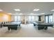 Billiards tables with modern lighting and ample seating in the game room at 1 Beach Se Dr # 1902, St Petersburg, FL 33701
