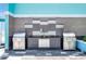 Outdoor grilling station with stainless steel grills, a sink, and attractive gray tile at 1 Beach Se Dr # 1902, St Petersburg, FL 33701