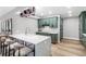 Modern kitchen features green cabinets, a stylish island, and wood flooring at 1 Beach Se Dr # 1902, St Petersburg, FL 33701