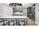 Modern kitchen features green cabinets, a stylish island, and wood flooring at 1 Beach Se Dr # 1902, St Petersburg, FL 33701