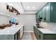 Contemporary kitchen with green cabinets and counter, open to dining area with ocean views at 1 Beach Se Dr # 1902, St Petersburg, FL 33701