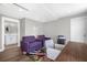 Office area with two purple chairs, colorful rug, wooden floors, a printer and adjacent bathroom at 1 Beach Se Dr # 1902, St Petersburg, FL 33701