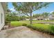Spacious backyard with well-maintained lawn, mature trees, and scenic pond views at 10263 Devonshire Lake Dr, Tampa, FL 33647