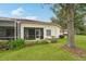 A tranquil backyard featuring a screened-in lanai and lush landscaping at 10263 Devonshire Lake Dr, Tampa, FL 33647