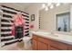 Bright bathroom features a shower-tub with a colorful curtain and a neutral-toned vanity with a white countertop at 10263 Devonshire Lake Dr, Tampa, FL 33647