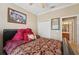 Inviting bedroom with neutral paint, a cozy bed with red decorative pillows, and an ensuite bathroom at 10263 Devonshire Lake Dr, Tampa, FL 33647