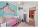 Charming bedroom with playful decorations, a ceiling fan with chandelier, and a large closet for ample storage at 10263 Devonshire Lake Dr, Tampa, FL 33647