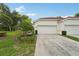 Charming home exterior with a well-manicured lawn and a two-car garage at 10263 Devonshire Lake Dr, Tampa, FL 33647