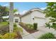 Charming single-story home with a well-manicured lawn and attached two-car garage at 10263 Devonshire Lake Dr, Tampa, FL 33647
