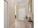 Inviting hallway with tiled floor and decorative table, leading to the home's entrance, creating a warm welcome at 10263 Devonshire Lake Dr, Tampa, FL 33647