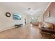 Bright and airy living room with neutral tones, tile floors, and comfortable seating arrangement at 10263 Devonshire Lake Dr, Tampa, FL 33647
