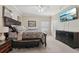 Comfortable main bedroom with a dark wood bed frame, plush carpeting, and a mounted television for easy viewing at 10263 Devonshire Lake Dr, Tampa, FL 33647