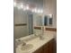 Bathroom with double sinks, large mirror, and updated vanity lighting at 10713 Shady Preserve Dr, Riverview, FL 33579