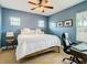 Bedroom with blue walls, a ceiling fan and large windows offering plenty of natural light at 10713 Shady Preserve Dr, Riverview, FL 33579