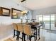 Bright dining area features a modern light fixture and slider doors to the outdoor living space at 10713 Shady Preserve Dr, Riverview, FL 33579