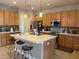 Spacious kitchen featuring wooden cabinets, a large center island, and stainless steel appliances at 10713 Shady Preserve Dr, Riverview, FL 33579