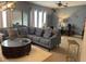 Cozy living room with a plush sectional sofa, decorative mirrors, and a soft rug for added comfort at 10713 Shady Preserve Dr, Riverview, FL 33579
