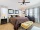 Comfortable main bedroom with a large bed, ceiling fan, and ample natural light at 10713 Shady Preserve Dr, Riverview, FL 33579