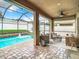 Covered patio with comfortable seating overlooks the screened pool area with fountain at 10713 Shady Preserve Dr, Riverview, FL 33579