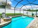 Beautiful screened pool with a fire pit and outdoor kitchen area perfect for entertaining at 10713 Shady Preserve Dr, Riverview, FL 33579