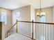 Bright and airy staircase with natural light and modern chandelier at 10713 Shady Preserve Dr, Riverview, FL 33579