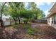 Private backyard surrounded by mature shade trees and a fenced perimeter at 10841 Casa Grande Ave, Port Richey, FL 34668
