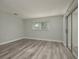 Bedroom with wood floors and sliding glass door to the exterior at 10841 Casa Grande Ave, Port Richey, FL 34668