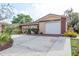 Attractive single-story home featuring a garage and nicely landscaped front yard at 10841 Casa Grande Ave, Port Richey, FL 34668